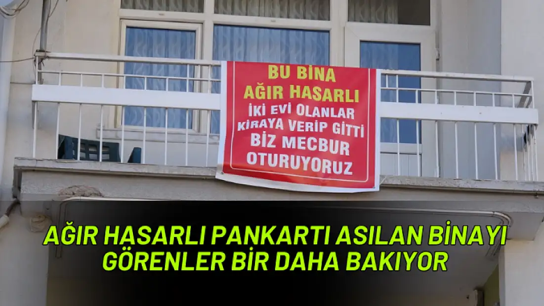 Ağır hasarlı pankartı asılan binayı görenler bir daha bakıyor
