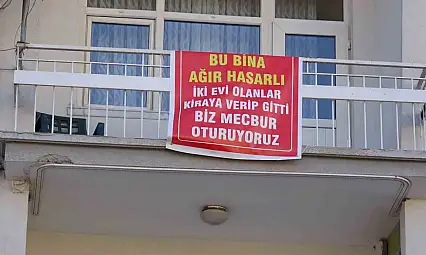 Ağır hasarlı pankartı asılan binayı görenler bir daha bakıyor